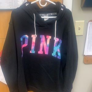 Black size large pink hoodie with multi color tye dye PINK written across chest
